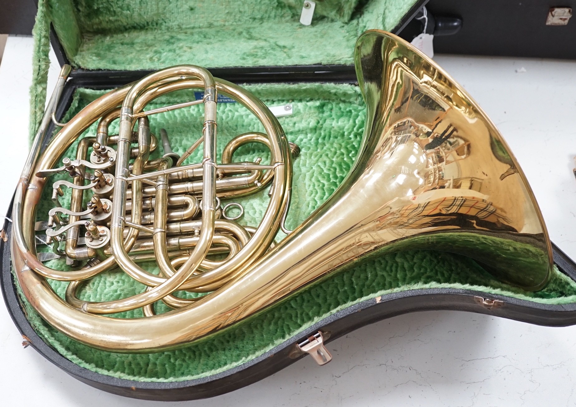 A cased brass telescope and tripod stand, together with a CorTon for Paxman French horn (cased)